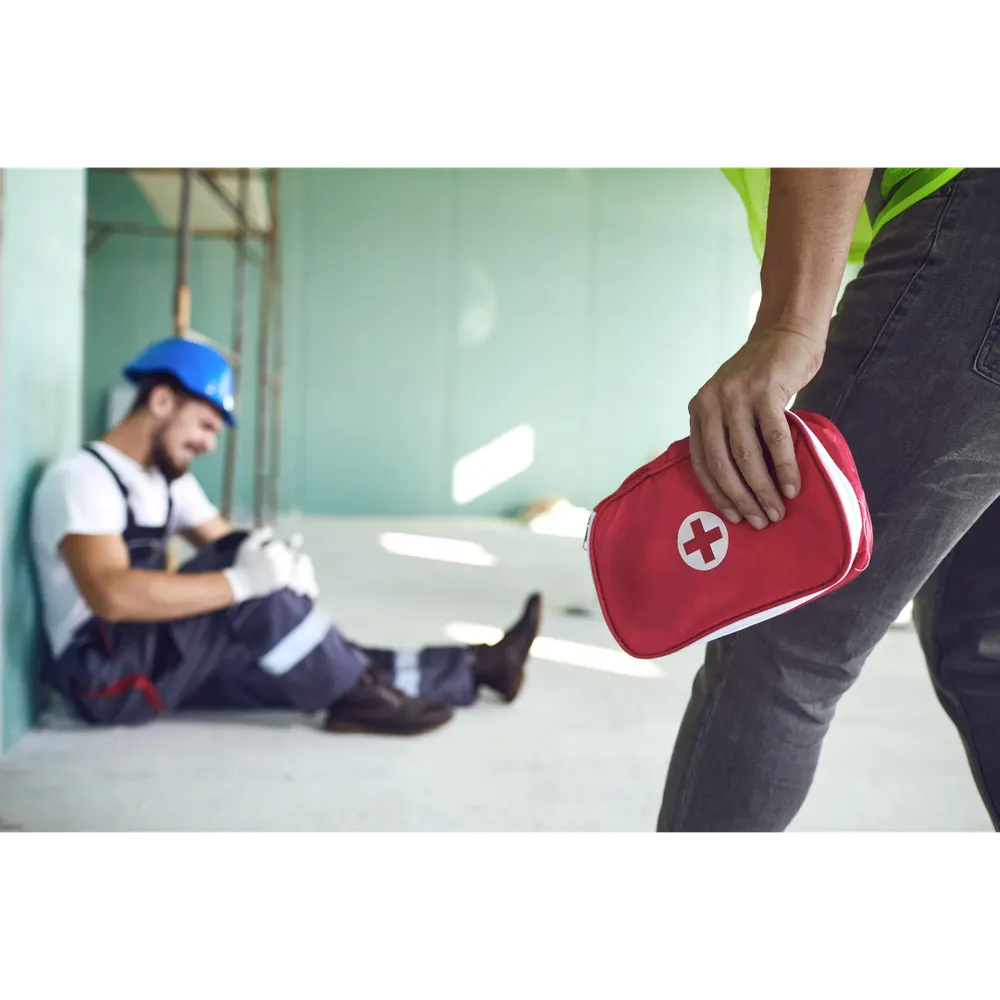 A first aider treating an injured worker